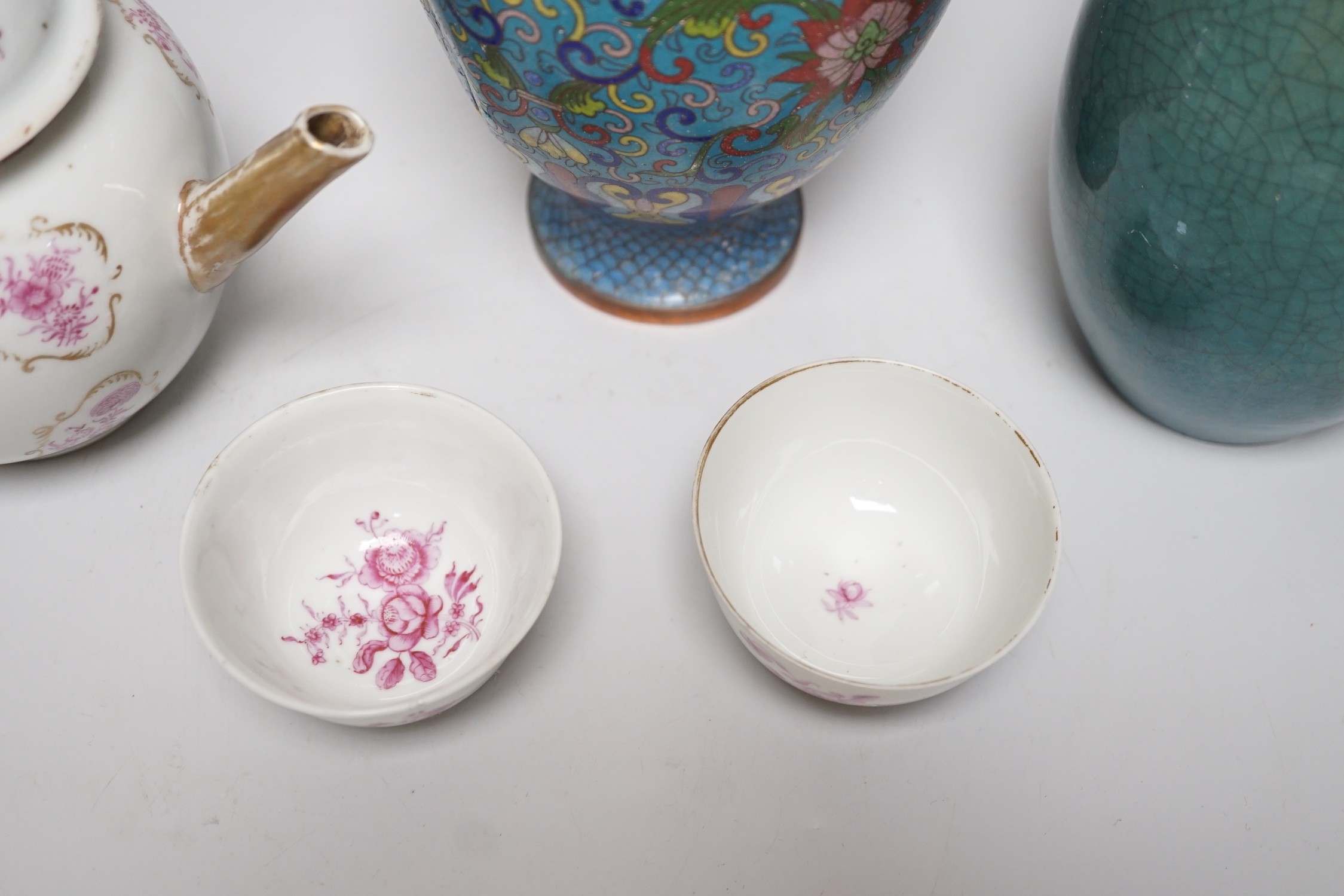 A selection of Oriental ceramics, to include a Chinese pink enamelled export teapot and matching tea bowls, a cloisonné blue ground vase, and a blue Japanese crackle glaze, (5). Tallest 23cm